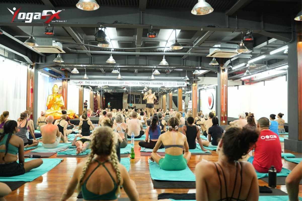Group of yoga teacher training candidates in YogafX practicing together during a supervised intensive