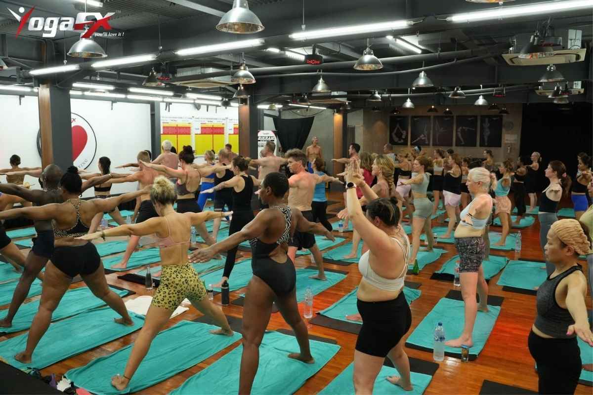 Group of yoga teacher training graduates holding certificates after completing a bikram yoga instructor course