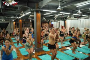 Yoga student practising a hot yoga posture during Bikram-style teacher training in a heated studio