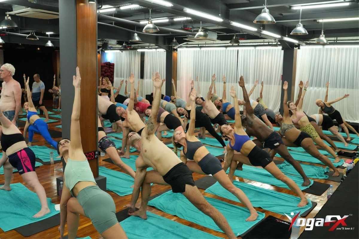 Yoga class in session, illustrating the format differences between traditional and hybrid bikram yoga teacher training programmes