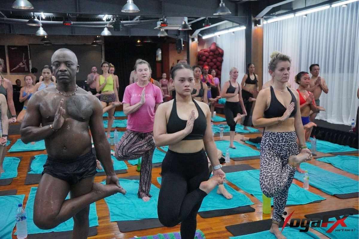 Group practising yoga outdoors in Bali, reflecting the tropical setting of the YogaFX bikram yoga teacher training UK students travel for