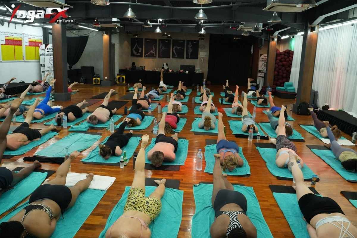 YogaFX 6-day hybrid yoga teacher training cohort practicing in Seminyak, Bali with lead trainer.