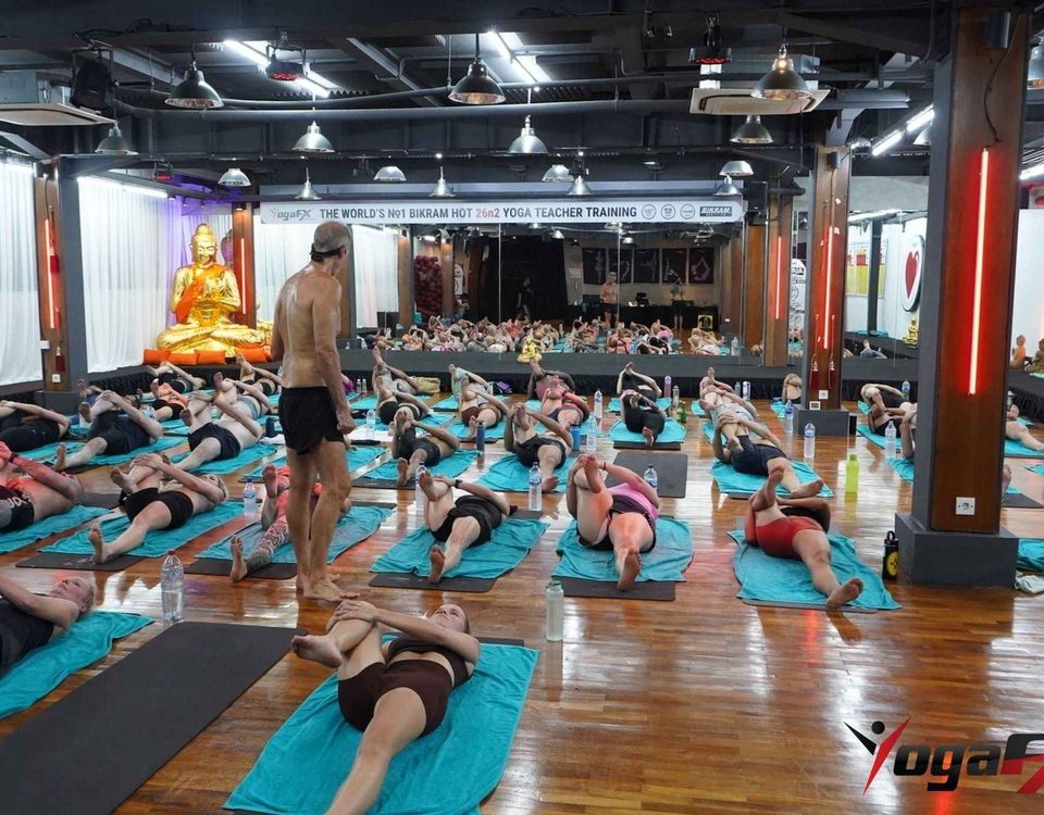 Mr. Ian Terry supervising a trainee's teaching practicum during hot yoga teacher training at the YogaFX academy in Bali