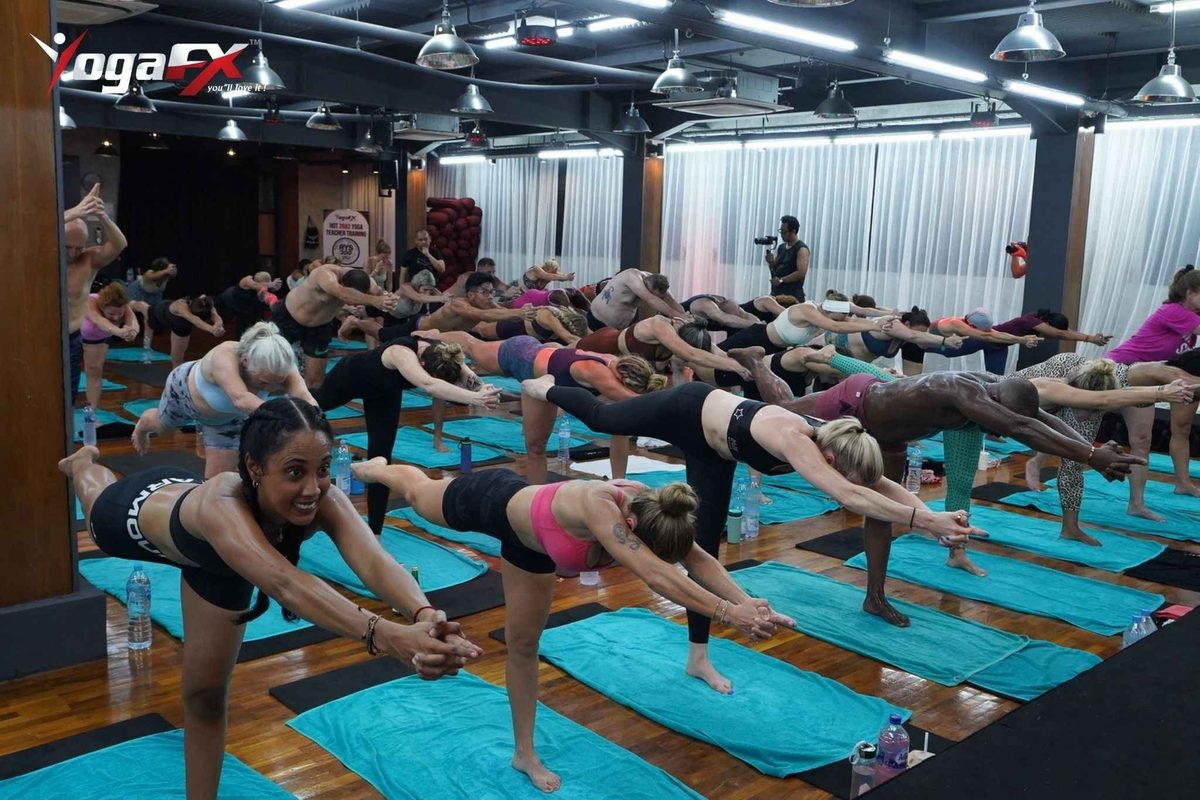 UK-based trainee comparing online yoga certification modules with in-person teaching practice