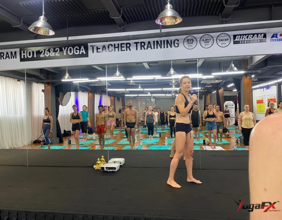 How many men do yoga: men and women standing side by side in a mixed hot yoga class as the teacher speaks
